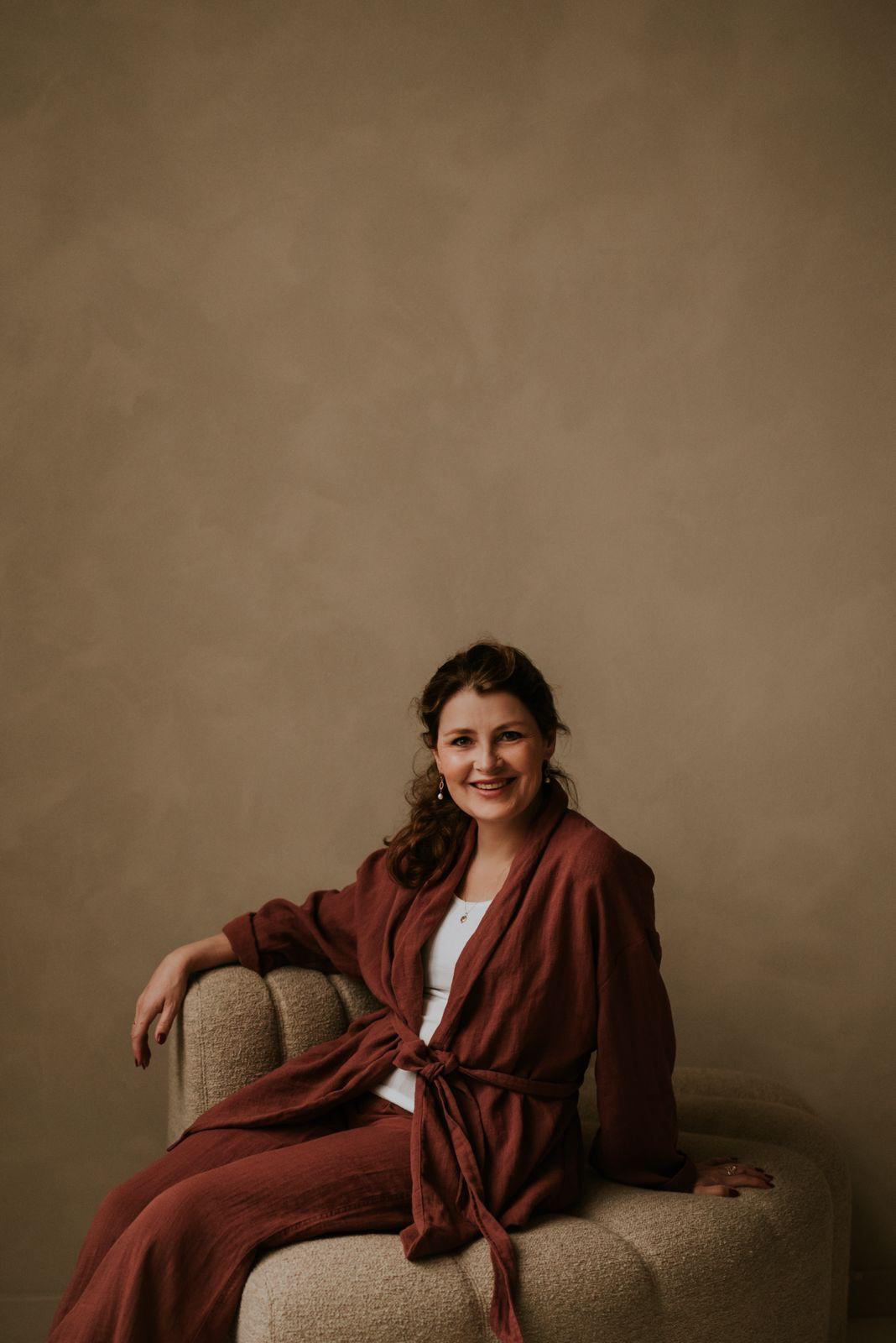 Chetanya de Wit seated in a warm studio portrait